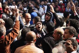 Mourners react during the funeral of killed Egyptian activists Amro Saad and Mohammed al-Guindi outside Omar Makram Mosque in Cairo's Tahrir Square on February 4, 2013. Saad died in clashes during anti-government protests on February 1, while Guindi, 28, went missing last month after joining protests demanding change on the second anniversary of Egypt's uprising against former president Hosni Mubarak and then slipped into a coma following days in police custody, according to the health ministry and his party. AFP PHOTO/GIANLUIGI GUERCIA
