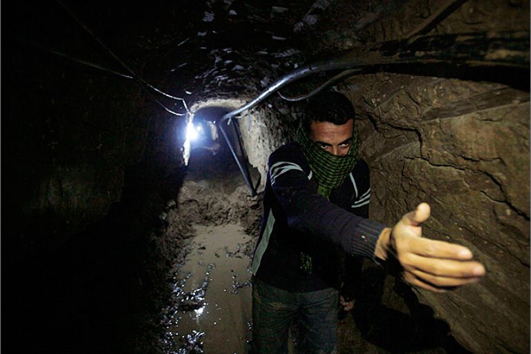 A Palestinian works inside a smuggling tunnel flooded by Egyptian forces, beneath the Egyptian-Gaza border in Rafah, in the southern Gaza Strip February 19, 2013. Egypt will not tolerate a two-way flow of smuggled arms with the Gaza Strip that is destabilising its Sinai peninsula, a senior aide to its Islamist president said, explaining why Egyptian forces flooded sub-border tunnels last week. To match Interview PALESTINIANS-TUNNELS/EGYPT/ REUTERS/Ibraheem Abu Mustafa (GAZA - Tags: POLITICS CIVIL UNREST)