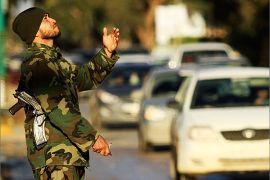A security officer gestures as he patrols around the city ahead of the country's two-year anniversary marking the ouster of Muammar Gaddafi, in Benghazi February 12, 2013. REUTERS/Esam Al-Fetori (LIBYA - Tags: POLITICS CIVIL UNREST)