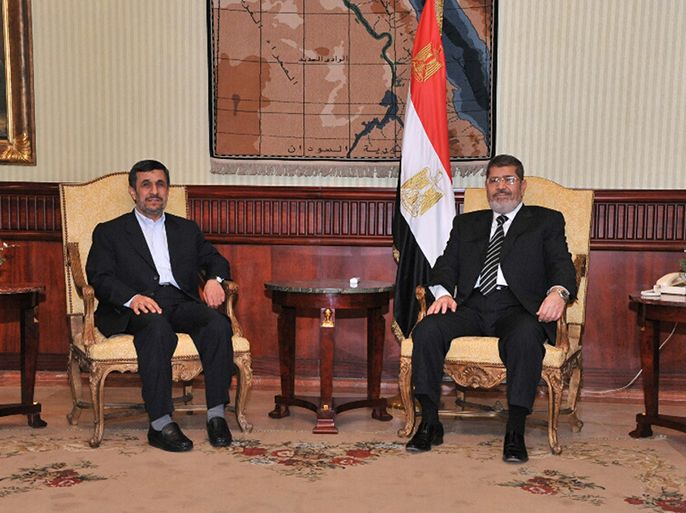 Egyptian President Mohamed Mursi (R), meets with Iran's President Mahmoud Ahmadinejad after he arrived at International Airport in Cairo in this photo provided by the Egyptian Presidency on February 5, 2013. Ahmadinejad arrived in Egypt on Tuesday on the first trip by an Iranian head of state since the 1979 revolution, underlining the thaw in relations since Egyptians elected an Islamist head of state. REUTERS/Egyptian Presidency/Handout (EGYPT - Tags: POLITICS TPX IMAGES OF THE DAY) ATTENTION EDITORS - THIS IMAGE WAS PROVIDED BY A THIRD PARTY. FOR EDITORIAL USE ONLY. NOT FOR SALE FOR MARKETING OR ADVERTISING CAMPAIGNS. THIS PICTURE IS DISTRIBUTED EXACTLY AS RECEIVED BY REUTERS, AS A SERVICE TO CLIENTS