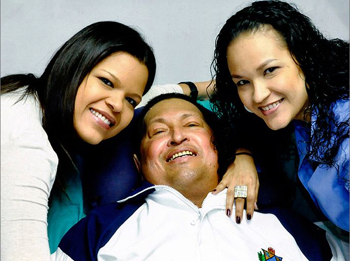 Venezuela's President Hugo Chavez smiles in between his daughters, Rosa Virginia (R) and Maria while recovering from cancer surgery in Havana in this photograph released by the Ministry of Information on February 15, 2013. Venezuela's government published the first pictures of cancer-stricken Chavez since his operation in Cuba more than two months ago, showing him smiling while lying in bed reading a newspaper, flanked by his two daughters. The 58-year-old socialist leader had not been seen in public since the Dec. 11 surgery, his fourth operation in less than 18 months. The government said the photos were taken in Havana on February 14, 2013. REUTERS/Ministry of Information/Handout (VENEZUELA -
