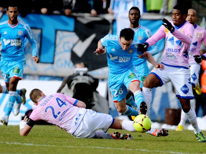 Marseille's French midfielder Matthieu Valbuena (C) vies with Evian's French midfielder Olivier Sorlin (L, bottom) and Evian's Brazilian defender Betao (R) during the French L1 football match Evian (ETGFC) vs Marseille (OM) on February 10, 2013 at the city stadium Parc des sports in Annecy, eastern France. AFP PHOTO / JEAN-PIERRE CLATOT