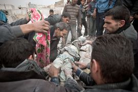Syrians carry the body of a 6-year-old girl found under the rubble of a building in the Tariq al-Bab district of the northern city of Aleppo on February 23, 2013. Three surface-to-surface missiles fired by Syrian regime forces in Aleppo's Tariq al-Bab district have left 58 people dead, among them 36 children, the Syrian Observatory for Human Rights said on February 24. AFP PHOTO/PABLO TOSCO