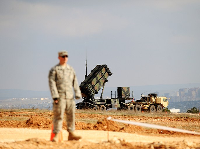 A US soldier stands near a Patriot missile system at a Turkish military base in Gaziantep on February 5, 2013. The United States, Germany and the Netherlands committed to send two missile batteries each and up to 400 soldiers to operate them after Ankara asked for help to bolster its air defences against possible missile attack from Syria. AFP PHOTO / BULENT KILIC