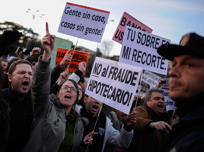 People attend a demonstration called by the organisation Platform for Mortgage Victims (PAH) to push for a new law to end a wave of evictions of homeowners ruined by the economic crisis, on February 16, 2013 in Madrid. Similar protests were called in 50 other Spanish cities, the latest of months of demonstrations driven by anger at Spain's recession and the conservative government, which is imposing austere economic reforms. Campaigners passed a rare milestone on February 12, 2013 when the Spanish parliament agreed to debate a popular bill of measures to protect poor homeowners, backed by a petition that received more than 1.4 million signatures. AFP PHOTO / PEDRO ARMESTRE