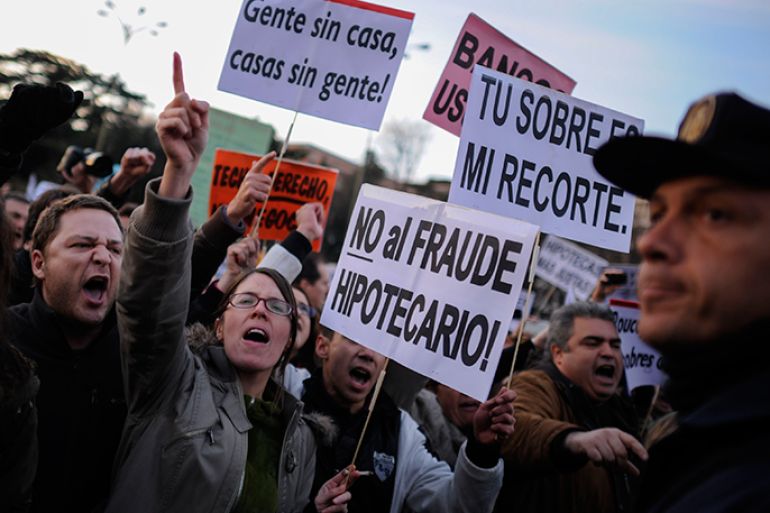 People attend a demonstration called by the organisation Platform for Mortgage Victims (PAH) to push for a new law to end a wave of evictions of homeowners ruined by the economic crisis, on February 16, 2013 in Madrid. Similar protests were called in 50 other Spanish cities, the latest of months of demonstrations driven by anger at Spain's recession and the conservative government, which is imposing austere economic reforms. Campaigners passed a rare milestone on February 12, 2013 when the Spanish parliament agreed to debate a popular bill of measures to protect poor homeowners, backed by a petition that received more than 1.4 million signatures. AFP PHOTO / PEDRO ARMESTRE