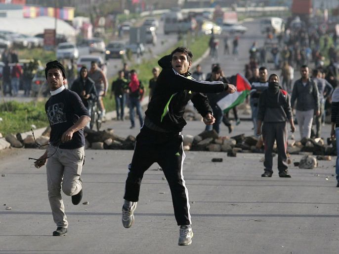 Palestinian protestors hurl stones towards Israeli security forces during clashes at the entrance of the Jalama checkpoint, near the West Bank city of Jenin, on February 24, 2013. Israel demanded of Palestinian leaders to quell unrest as thousands of detainees in Israeli jails staged a one-day hunger strike a day after an inmate died, and their supporters clashed with security forces