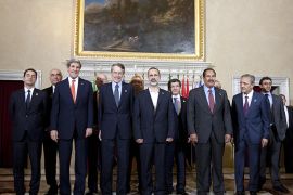 (From L, front row) France's ambassador to Syria Eric Chevallier, US Secretary of State John Kerry, Syrian National Coalition President Mouaz al-Khatib, Turkish Foreign Minister Ahmet Davutoglu, Qatar's Prime Minister and Foreign Minister Sheikh Hamad bin Khalifa al-Thani pose during the family photo of a meeting of the "Friends of the Syrian People (FOSP) Ministerial" group on February 28, 2013 in Rome. during a joint press conference at the end of a meeting of the "Friends of the Syrian People (FOSP) Ministerial" group on February 28, 2013 in Rome. AFP PHOTO / POOL / CLAUDIO PERI