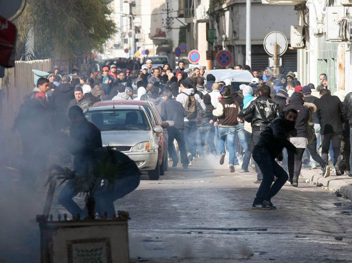 Tunisian protestors clash with security forces outside the Interior Ministry in Tunis, on February 7, 2013 following a demonstration against the killing of opposition figure and human rights lawyer Chokri Belaid. Police was deployed in force in the Tunisian capital amid fears the murder of the 48-year-old opposition figure could reignite nationwide violence, as the ruling Islamists broke ranks over how to defuse the crisis