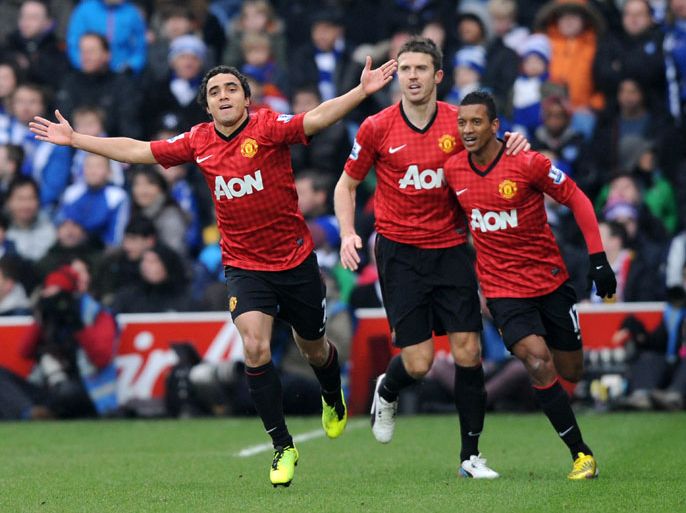 Manchester United's Brazilian defender Rafael da Silva (L) celebrates scoring the opening goal with English midfielder Michael Carrick (2nd L) and Portuguese midfielder Nani (R) during the English Premier League football match between Queens Park Rangers and Manchester United at Loftus Road in London on February 23, 2012. AFP PHOTO/OLLY GREENWOOD