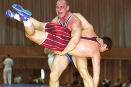 MIN02-19980424-MINSK, BELARUS - Russia's legendary Alexander Karelin (standing) throws Belarussian Dmitry Sebelko and wins the fight during the Greek-Roman wrestling championship in Minsk, 24 April 1998.