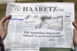 A woman reads the latest issue of the Haaretz daily newspaper whose cover page raises a question on the alleged suicide of an Australian prisoner with ties to Mossad on February 13, 2013 in Jerusalem. Twenty-four hours after the emergence of an explosive investigative report by Australia's ABC news, the Israeli censor moved to ease the total blackout on coverage of the incident, allowing the local press to publish details from the report. AFP PHOTO/AHMAD