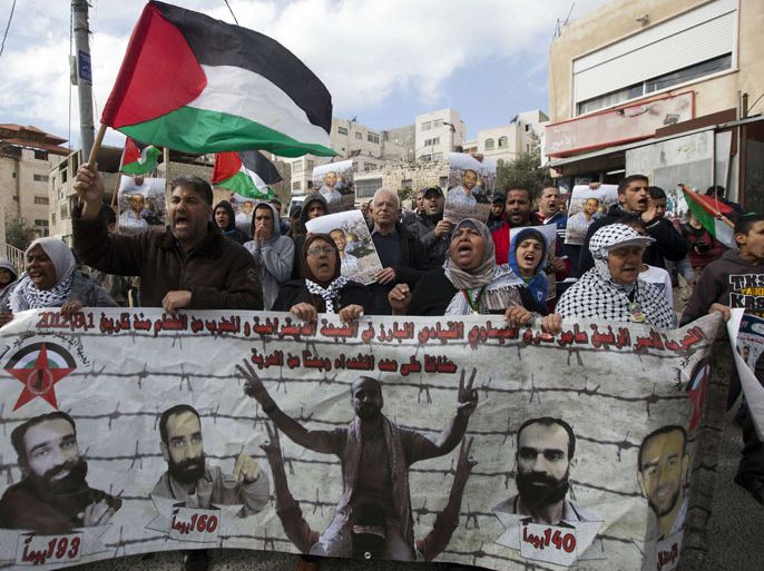 Palestinian protestors wave their national flag and hold portraits of Samer Issawi, a Palestinian prisoner who has been on hunger strike for more than 200 days in an Israeli pirson, during a demonstration demanding for his release in the Arab east Jerusalem neighbourhood of Issawiya on February 15, 2013. A United Nations official on February 13, expressed concern about the wellbeing of Palestinian detainees in Israeli prisons and in particular about the condition of Issawi. AFP PHOTO/AHMAD GHARABLI Palestinian protestors wave their national flag and hold portraits of Samer Issawi, a Palestinian prisoner who has been on hunger strike for more than 200 days in an Israeli pirson, during a demonstration demanding for his release in the Arab east Jerusalem neighbourhood of Issawiya on February 15, 2013. A United Nations official on February 13, expressed concern about the wellbeing of Palestinian detainees in Israeli prisons and in particular about the condition of Issawi. AFP PHOTO/AHMAD GHARABLI