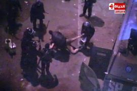 An image grab taken from Al-Hayat TV purportedly shows Egyptian riot policemen dragging and beating an unidentified naked man during clashes with anti-president protesters outside the Egyptian Presidential Palace on February 1, 2013 in Cairo. Egypt's presidency said it was "pained by the shocking footage" during overnight clashes outside the presidential palace that has outraged the opposition. AFP
