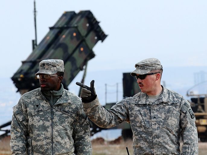 US soldiers stand near a Patriot missile system at a Turkish military base in Gaziantep on February 5, 2013. The United States, Germany and the Netherlands committed to send two missile batteries each and up to 400 soldiers to operate them after Ankara asked for help to bolster its air defences against possible missile attack from Syria. AFP PHOTO / BULENT KILIC