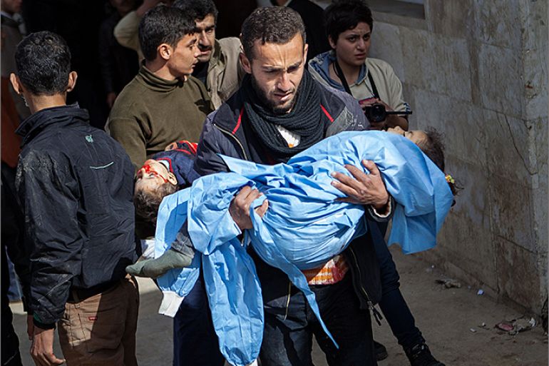 TOPSHOTS Relatives carry the bodies of 5-year old Elaf Daeef, and her 2-year old brother, Abdo Alhade Daeef, out of a hospital in Kfar Nubul after they were killed in an air strike on the town of Hass, in the northern Syrian province of Idlib, on February 14, 2013. A Syrian army jet fighter plane made an airstrike just after midday on the town of Hass killing at least 12 people, including four children. AFP PHOTO / DANIEL LEAL-OLIVAS
