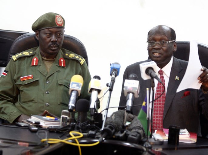 epa03185661 South Sudanese Minister of Information Barnaba Marial (R) speaks during a press conference with Spokesman of South Sudanese army Colonel Philip Aqoir (L) on the recent border clashes with Sudan, in Juba, South Sudan, 17 April 2012. According to media reports quoting officials on 17 April, the South Sudanese army shot down a Sudanese warplane over Heglig, the disputed oil-rich area along the border with the two countries. South Sudanese forces seized Heglig nearly a week ago, raising tensions between Juba and Khartoum. EPA/PHILIP DHIL