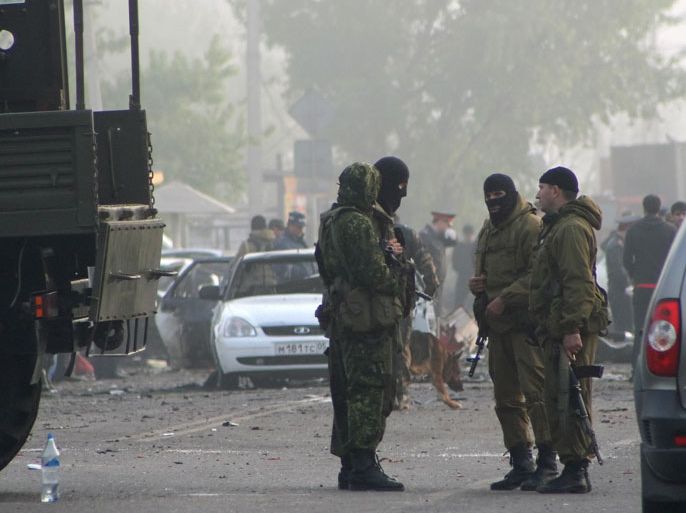 epa03205592 Dagestani policemen stand at the site of a suspected terrorist blast in the outskirts of Makhachkala, capital of the republic of Dagestan, Russia, 04 May 2012. Thirteen people were killed and more than 100 injured during double suicide explosions late on 03 May 2012. EPA/ABDULA MAGOMEDOV