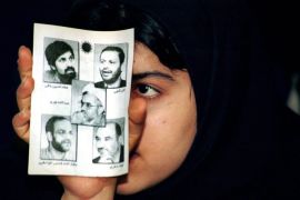 An Iranian reformist student is supporting jailed journalists at Tehran's Amir Kabir university holding portraits during a rally, 06 May 2003. The pamphlet shows jailed journalists Emadeddin Baghi (1st L), Akbar Ganji (2nd L), Abdollah Nuri (C), Mashallah Shmsolvaezin (1st down) and Latif Safari 2nd down). Iran is well-known to hold freedom of expressions, while closing of anti government newspapers and jailed people including journalists are everyday business.