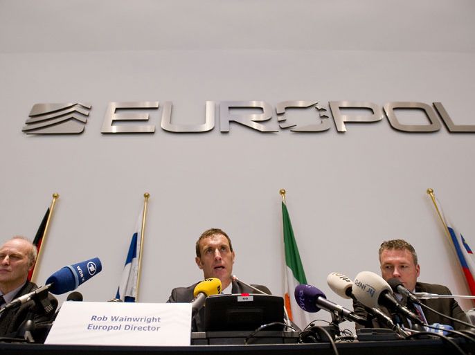 The Hague, -, NETHERLANDS : Europol's chief Rob Wainwright (C) speaks next to Friedhelm Althans, chief investigator of Bochum police (L) and Andreas Bachmann (R) from the Bochum prosecution service during a press conference in The Hague on February 4, 2013 after the police smashed a criminal network suspected of fixing 380 football matches, including in the Champions League and World Cup qualifiers. "It is clear to us that this is the biggest investigation ever into suspected match fixing," Wainwright told journalists. AFP PHOT / ANP / ROBIN VAN LONKHUIJSEN netherlands out - belgium ou