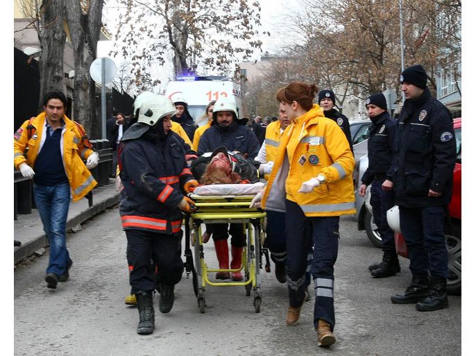Ankara, Ankara, TURKEY : Rescuers take on February 1, 2013 a victim of a blast outside the US Embassy in Ankara to a waiting ambulance. Two security guards were killed in the blast outside the US embassy, local television reported, amid speculation it was a suicide attack. The force of the explosion damaged nearby buildings in the Cankaya neighborhood where many other state institutions and embassies are also located. AFP PHOTO / ADEM ALTAN
