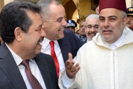 SEN49 - Fes, -, MOROCCO : Moroccan Prime Minister Abdelilah Benkirane (R), the Mayor of Fez and Secretary General of the Istiqlal Party Hamid Chabat (L), and a security official (C) speak following the inauguration of the Slat Alfassiyine synagogue in the northern city of Fez, on February 13, 2013. The two-year restoration of the 17th century synagogue bore "eloquent testimony to the spiritual wealth and diversity of the Kingdom of Morocco and its heritage," Moroccan King Mohammed said in a message read by Benkirane. AFP PHOTO/FADEL SENNA