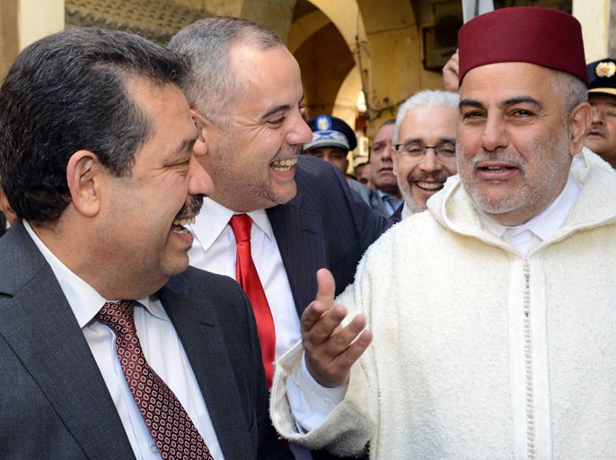 SEN49 - Fes, -, MOROCCO : Moroccan Prime Minister Abdelilah Benkirane (R), the Mayor of Fez and Secretary General of the Istiqlal Party Hamid Chabat (L), and a security official (C) speak following the inauguration of the Slat Alfassiyine synagogue in the northern city of Fez, on February 13, 2013. The two-year restoration of the 17th century synagogue bore "eloquent testimony to the spiritual wealth and diversity of the Kingdom of Morocco and its heritage," Moroccan King Mohammed said in a message read by Benkirane. AFP PHOTO/FADEL SENNA