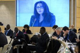 Geneva, Genève, SWITZERLAND : French Minister Delegate for Francophony, Yamina Benguigui appears on a giant screen while addressing the assembly during the 22nd session of the United Nations Human Rights Council on February 26, 2013 in Geneva. AFP PHOTO / FABRICE COFFRINI