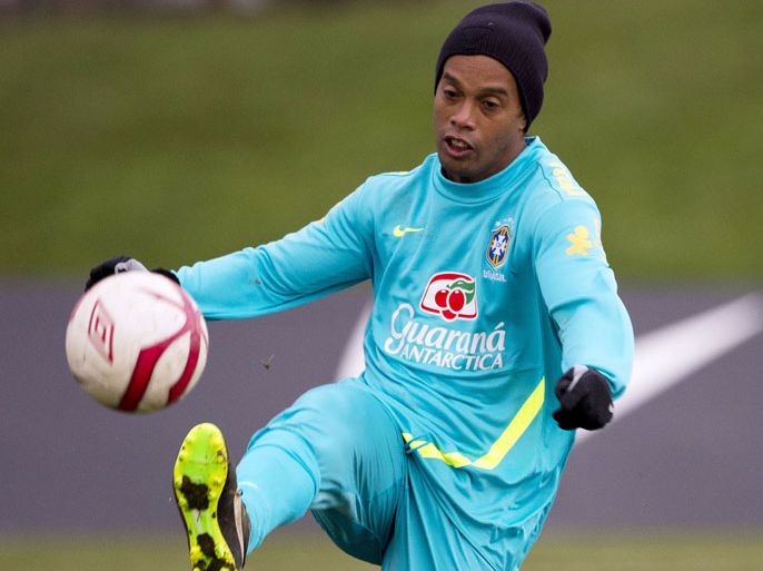 Brazilian footballer Ronaldinho controls a ball during a training session at The Hive, Barnet FC's training ground in Edgware, London on February 5, 2013. Ronaldinho admits he did not expect to be recalled by Brazil, but says he believes the squad he has returned to possesses sufficient quality to win the 2014 World Cup on home soil. After a year in the international wilderness, the 32-year-old forward is expected to feature in Brazil's friendly game against England at Wembley on February 6, 2013. AFP PHOTO / ADRIAN DENNIS
