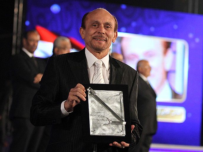 epa02504071 Egyptian actor Mohamed Sobhi poses for photographers after receiving an honorary award during the opening ceremony of the 16th Cairo festival for Arab Media at the Media production city, Egypt on 21 December 2010. EPA/MOHAMED OMAR