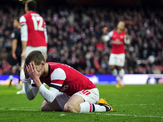 Arsenal's English midfielder Jack Wilshere reacts after missing a chance in the last few seconds of the English FA Cup fifth round football match between Arsenal and Blackburn Rovers at the Emirates Stadium in London on February 16, 2013. Blackburn won the game 1-0. AFP PHOTO/GLYN KIRK
