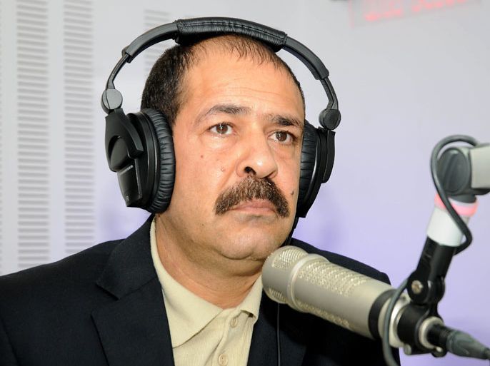 TUNISIA : A picture taken on November 20, 2012 shows Tunisian lawyer Chokri Belaid during a radio interview in Tunis. Prominent Tunisian opposition leader Chokri Belaid was gunned down outside his home in Tunis on February 6, 2013, sparking angry protests by his supporters and attacks on offices of the ruling Islamist Ennahda party. AFP PHOTO / KHALIL