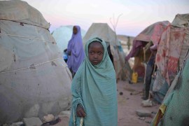 A girl stands in a camp for internally displaced persons (IDP) on the outskirts of Belet Weyne, about 315 km (196 miles) from the capital Mogadishu, February 20, 2013, in this picture provided by the African Union-United Nations Information Support (AU-UN IST) team. According to the AU-UN IST, the IDP camp is currently home to four hundred people displaced by floods that affected the region late last year. The AU-UN IST added that Belet Weyne, Somalia's fifth largest city, was first liberated from the extremist group al Shabab in September 2011 by Ethiopian troops, but was taken over by the Djiboutian contingent of the African Union Mission in Somalia (AMISOM) in September 2012. Picture taken February 20, 2013. REUTERS/Tobin Jones/AU-UN IST PHOTO/Handout (SOMALIA - Tags: SOCIETY POLITICS)