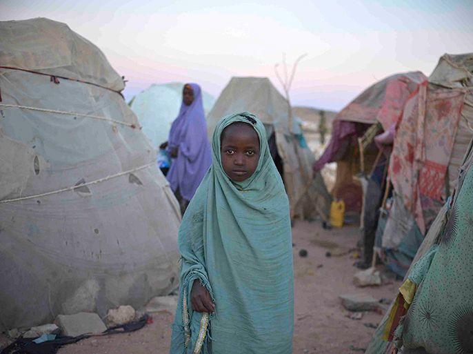 A girl stands in a camp for internally displaced persons (IDP) on the outskirts of Belet Weyne, about 315 km (196 miles) from the capital Mogadishu, February 20, 2013, in this picture provided by the African Union-United Nations Information Support (AU-UN IST) team. According to the AU-UN IST, the IDP camp is currently home to four hundred people displaced by floods that affected the region late last year. The AU-UN IST added that Belet Weyne, Somalia's fifth largest city, was first liberated from the extremist group al Shabab in September 2011 by Ethiopian troops, but was taken over by the Djiboutian contingent of the African Union Mission in Somalia (AMISOM) in September 2012. Picture taken February 20, 2013. REUTERS/Tobin Jones/AU-UN IST PHOTO/Handout (SOMALIA - Tags: SOCIETY POLITICS)
