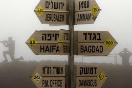 Statues of Israeli soldiers standing guard are seen next to a sign for tourists showing the different distances to Jerusalem, Baghdad, Damascus and other locations, at an army post in Mount Bental in the annexed Golan Heights on January 31, 2013. Iran's deputy foreign minister said that the alleged Israeli air strike on a Syrian military research facility a day earlier will have "grave consequences." AFP PHOTO / JACK GUEZ