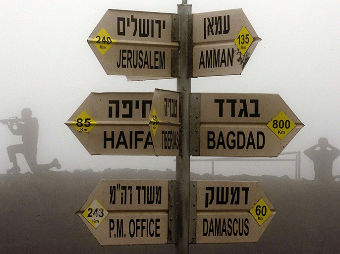 Statues of Israeli soldiers standing guard are seen next to a sign for tourists showing the different distances to Jerusalem, Baghdad, Damascus and other locations, at an army post in Mount Bental in the annexed Golan Heights on January 31, 2013. Iran's deputy foreign minister said that the alleged Israeli air strike on a Syrian military research facility a day earlier will have "grave consequences." AFP PHOTO / JACK GUEZ