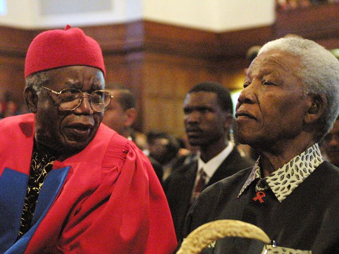 FILES) Acclaimed Nigerian author Chinua Achebe (L) and former South African President Nelson Mandela chat on September 12, 2002 prior to Achebe receiving an honorary degree of Doctor of Literature and delivering the third Steve Biko Memorial Lecture at the University of Cape Town. Nigerian novelist Chinua Achebe, the revered author of "Things Fall Apart" who has been called the father of modern African literature, has died aged 82, his publisher said on March 22, 2013. AFP PHOTO/ANNA ZIEMINSKI