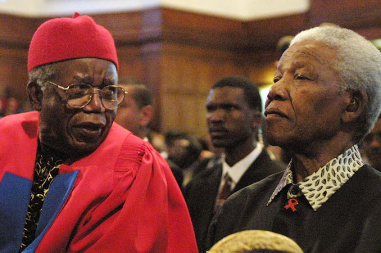 FILES) Acclaimed Nigerian author Chinua Achebe (L) and former South African President Nelson Mandela chat on September 12, 2002 prior to Achebe receiving an honorary degree of Doctor of Literature and delivering the third Steve Biko Memorial Lecture at the University of Cape Town. Nigerian novelist Chinua Achebe, the revered author of "Things Fall Apart" who has been called the father of modern African literature, has died aged 82, his publisher said on March 22, 2013. AFP PHOTO/ANNA ZIEMINSKI