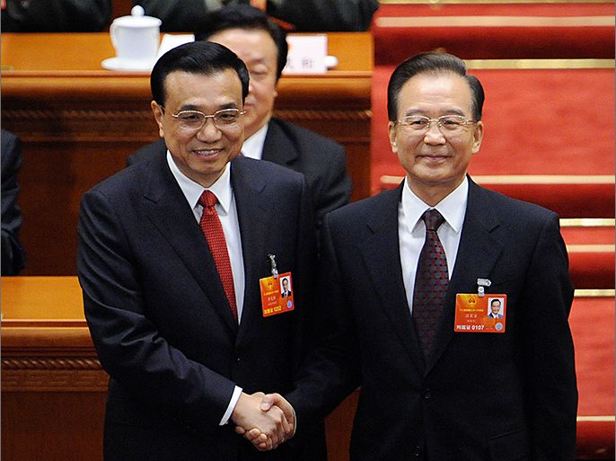 Newly-elected Chinese Premier Li Keqiang (L) shakes hands with former Premier Wen Jiabao (R) during the 12th National People's Congress (NPC) in the Great Hall of the People in Beijing on March 15, 2013. China's parliament installed bureaucrat Li Keqiang as premier on March 15, putting him in charge of running the world's second-largest economy in a final step of a landmark power transition. AFP PHOTO /WANG ZHAO