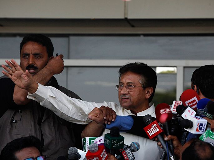 Pakistan's former President, Pervez Musharraf, waves to his supporters after his arrival from Dubai at Jinnah International airport in Karachi March 24, 2013. Musharraf returned home on Sunday after nearly four years of self-imposed exile to contest elections despite the possibility of arrest and a threat from the Taliban to kill him. REUTERS/Akhtar Soomro (PAKISTAN - Tags: POLITICS)
