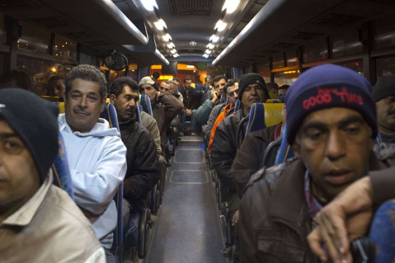 Palestinians sit in a bus as a new line is made available by Israel to take Palestinian labourers from the Israeli army crossing Eyal, near the West Bank town of Qalqilya, into the Israeli city Tel Aviv, on March 4, 2013.Thousands of Palestinians enter Israel to work every day after receiving permits, many of them in private vans. The new line will not be available for Jewish settlers. AFP PHOTO / MENAHEM KAHANA