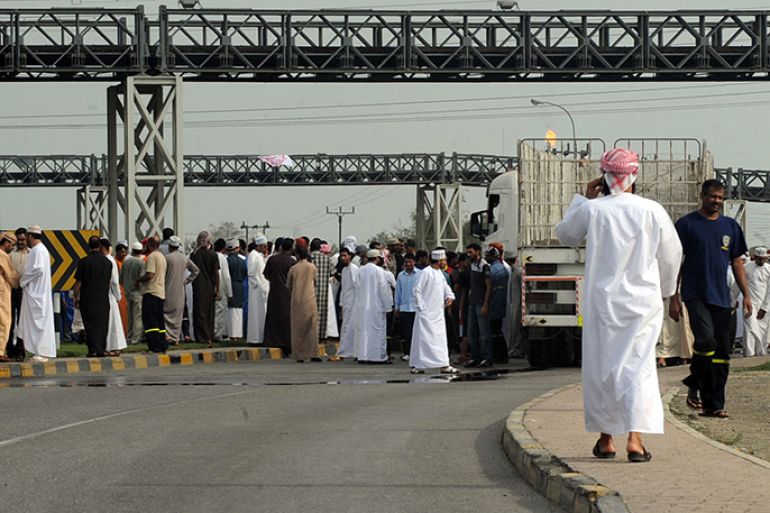 epa02607510 Omani protesters block a street as they take part in a demonstration calling for political reform in Sohar, some 250 kilometers north of Oman's capital Muscat, on 28 February 2011 after protesters allegedly set it on fire during protests calling for political reforms. According to media sources, two people were killed in Oman when security forces fired at protesters calling for political reforms. Some 2,000 people have taken to the streets in the industrial city of Sohar since 26 February, becoming the latest in a wave of protests sweeping across the Arab world and Middle East. EPA/HAMID Al-QASMI