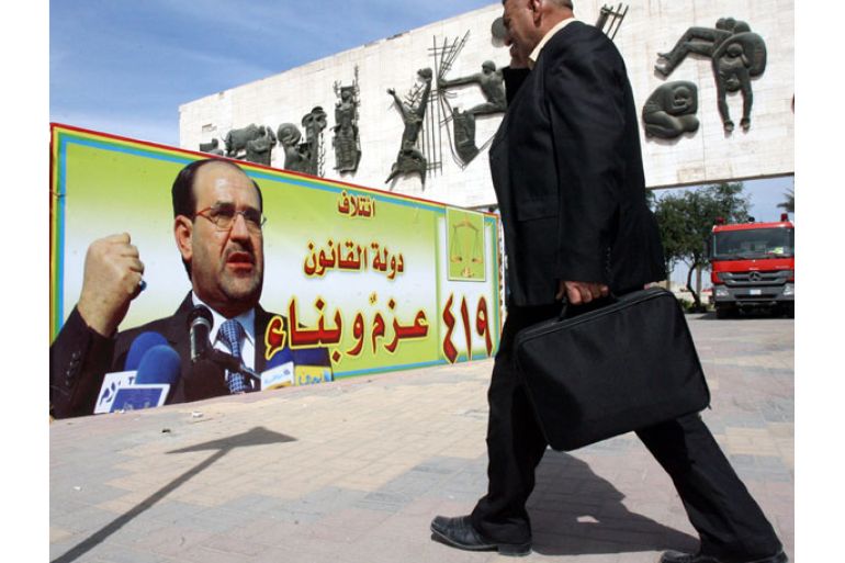 epa03632071 An Iraqi man passes an electoral poster for Iraqi Prime Minister Nouri al-Maliki in Al-Tahrir square, central Baghdad, Iraq, 19 March 2013. Iraqi political blocs are preparing for the upcoming provincial elections scheduled on 20 April 2013. A series of suicide and car bombings in Iraq killed at least 61 people on 19 March, the eve of the tenth anniversary of the US-led invasion. EPA/MOHAMMED JALIL