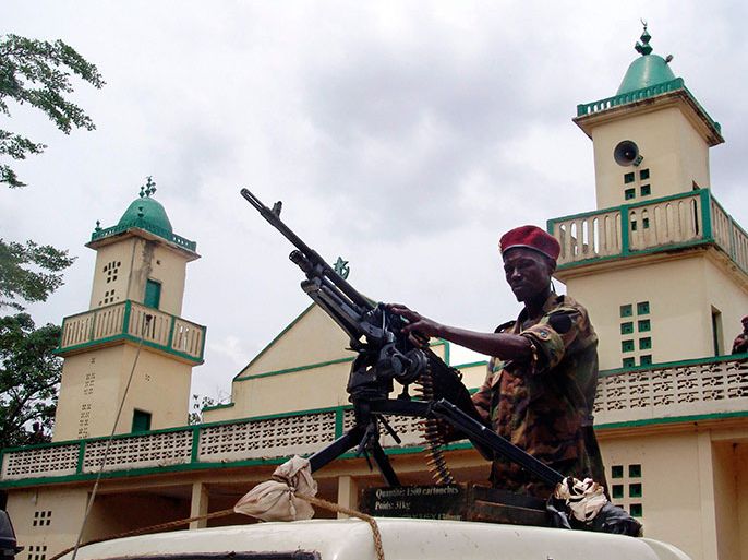 Soldiers from the Seleka rebel alliance stand guard as the Central African Republic's new President Michel Djotodia (not pictured) attends Friday prayers at the central mosque in Bangui March 29, 2013. REUTERS/Alain Amontchi (CENTRAL AFRICAN REPUBLIC)