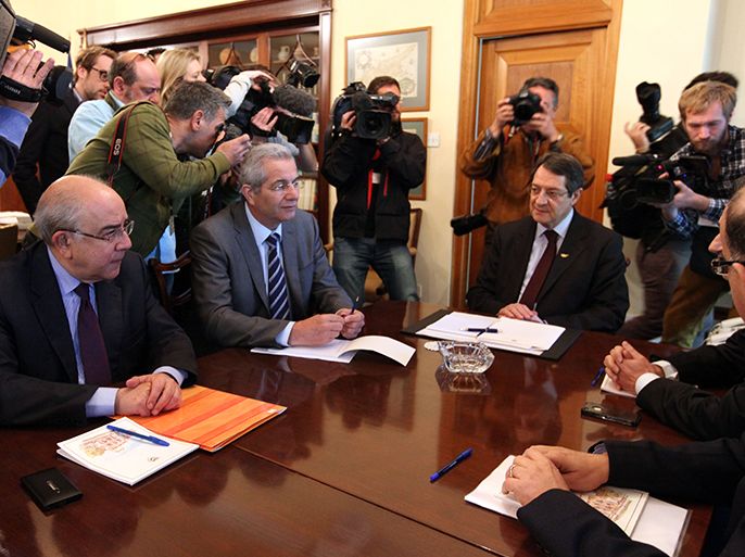 epa03632514 Cypriot President Nicos Anastasiades (R) presides over a meeting with leaders of political parties about the country's rejection to a proposed levy on bank deposits, at the presidential palace in Nicosia, Cyprus 20 March 2013. Lawmakers on 19 March overwhelmingly rejected a plan to take up to 10 per cent of people's bank deposits to secure a bailout by fellow eurozone countries and the International Monetary Fund (IMF) and prevent a collapse of the country's banks. EPA/KATIA CHRISTODOULOU