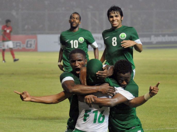 Saudi Arabian player Yousef Mansour (16) and his team celebrate a goal against Indonesia during their Group C 2015 Asian Cup qualifying match at Bung Karno stadium in Jakarta on March 23, 2013. Arab Saudi won 2-1. AFP PHOTO / Bay ISMOYO