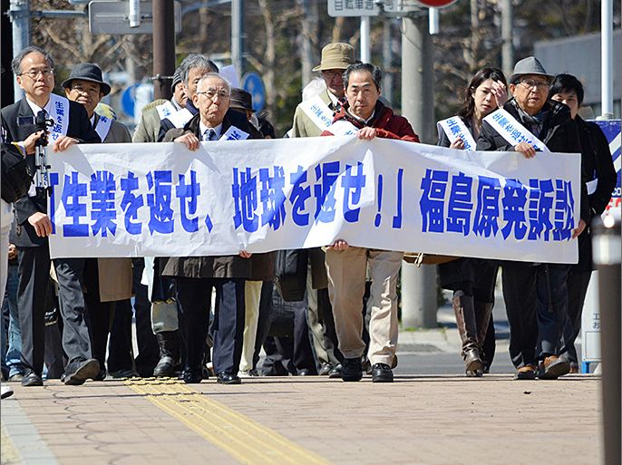 People affected by the Fukushima nuclear disaster march to the Fukushima District Court holding a banner which reads "Return our occupations (jobs) and return the earth" on March 11, 2013 to file a collective damages lawsuit against Tokyo Electric Power Co. (TEPCO), the operator of the Fukushima Dai-ichi nuclear power plant. Japan on March 11 marked the second anniversary of a ferocious tsunami that claimed nearly 19,000 lives and sparked the worst nuclear accident in a generation. JAPAN OUT AFP PHOTO / JIJI PRESS