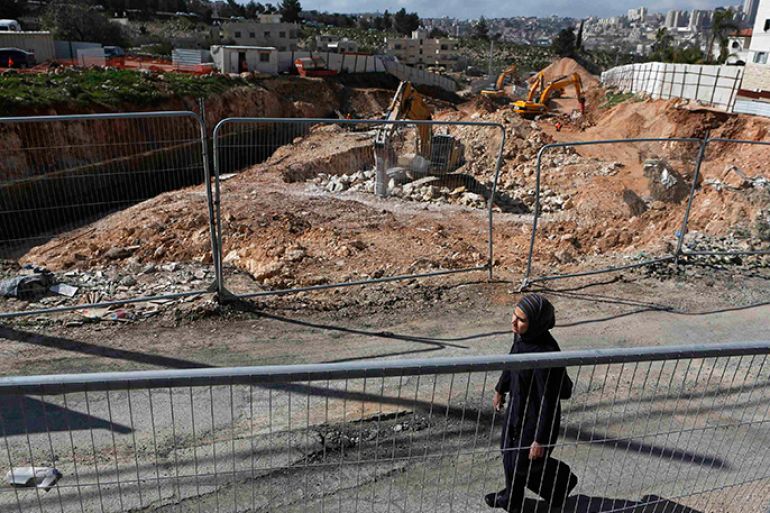 A woman walks past a road under construction in the Arab neighbourhood of Beit Safafa in Jerusalem February 28, 2013. The mechanical diggers start work soon after dawn, cutting through a leafy village on the outskirts of Jerusalem to build a six-lane highway that has become the latest focal point of Arab-Israeli discontent. The road leads directly to Jewish settlements, built on occupied land around the foothills of Bethlehem. When finished, it will allow the settlers to speed down to Israel's thriving coastal plains, unhindered by traffic lights or roundabouts.