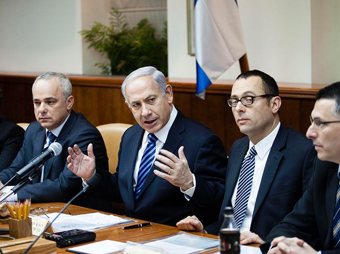 Israeli Prime Minister Benjamin Netanyahu (C) gestures as he speaks during the first cabinet meeting of the 33rd Israeli government, in Jerusalem March 18, 2013. Netanyahu's new governing coalition took office after a parliamentary vote on Monday with powerful roles reserved for supporters of settlers in occupied territory. REUTERS/David Vaaknin/Pool (JERUSALEM - Tags: POLITICS)