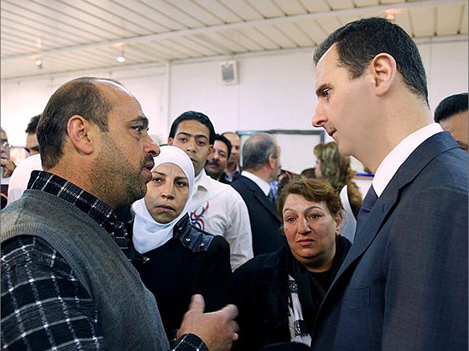 A handout picture from the Syrian Presidency Media Office shows Syrian President Bashar al-Assad (R) speaking with a Syrian man during his surprise visit to the Educational Centre for Fine Arts in the capital Damascus on March 20, 2013. Assad made a visit to the centre where the education ministry was honouring the families of students who were martyred as a result of terrorist acts. AFP PHOTO/HO/SYRIAN PRESIDENCY MEDIA OFFICE === RESTRICTED TO EDITORIAL USE - MANDATORY CREDIT "AFP PHOTO / HO /SYRIAN PRESIDENCY MEDIA OFFICE " - NO MARKETING NO ADVERTISING CAMPAIGNS - DISTRIBUTED AS A SERVICE TO CLIENTS ==